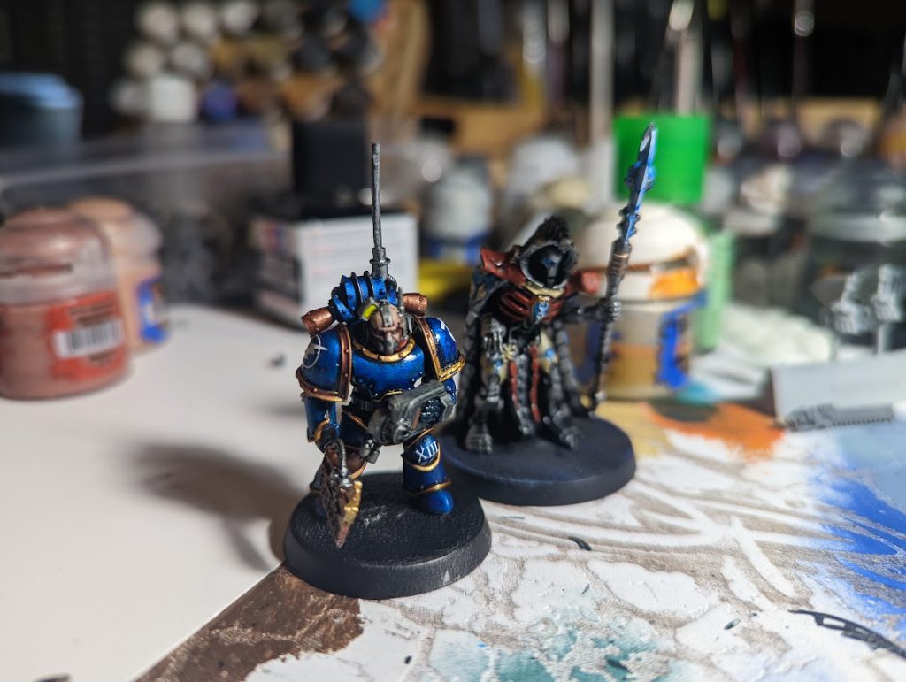 Ultramarines Master of Signal Consuil with Legatine Axe and Ultramarines Armistos Consul with Empathetic Obliterator.