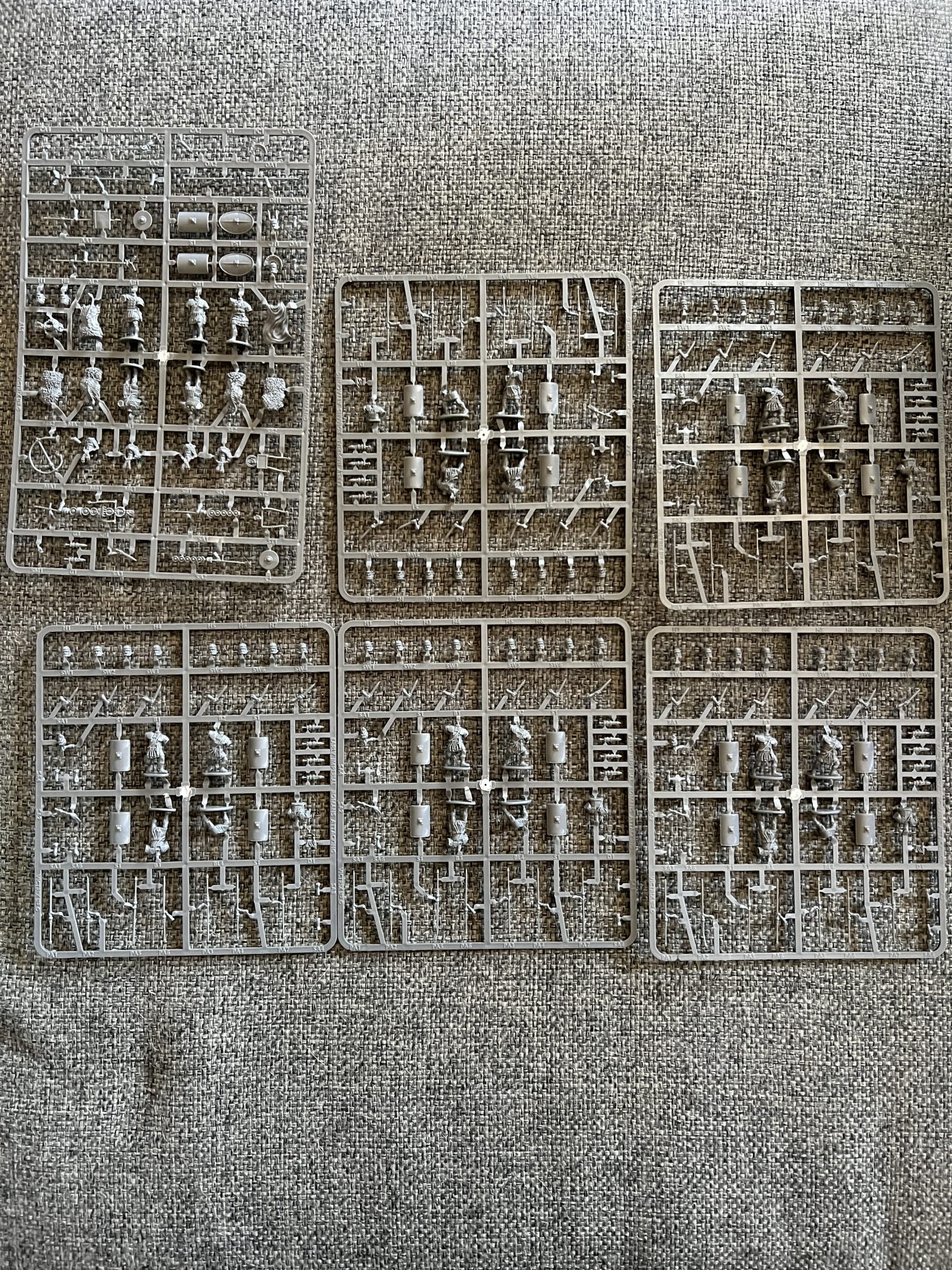 A collection of sprues containing miniatures of Roman Legionnaires.