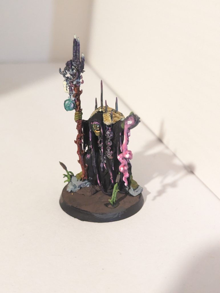 An Orc in black robes with pink goo