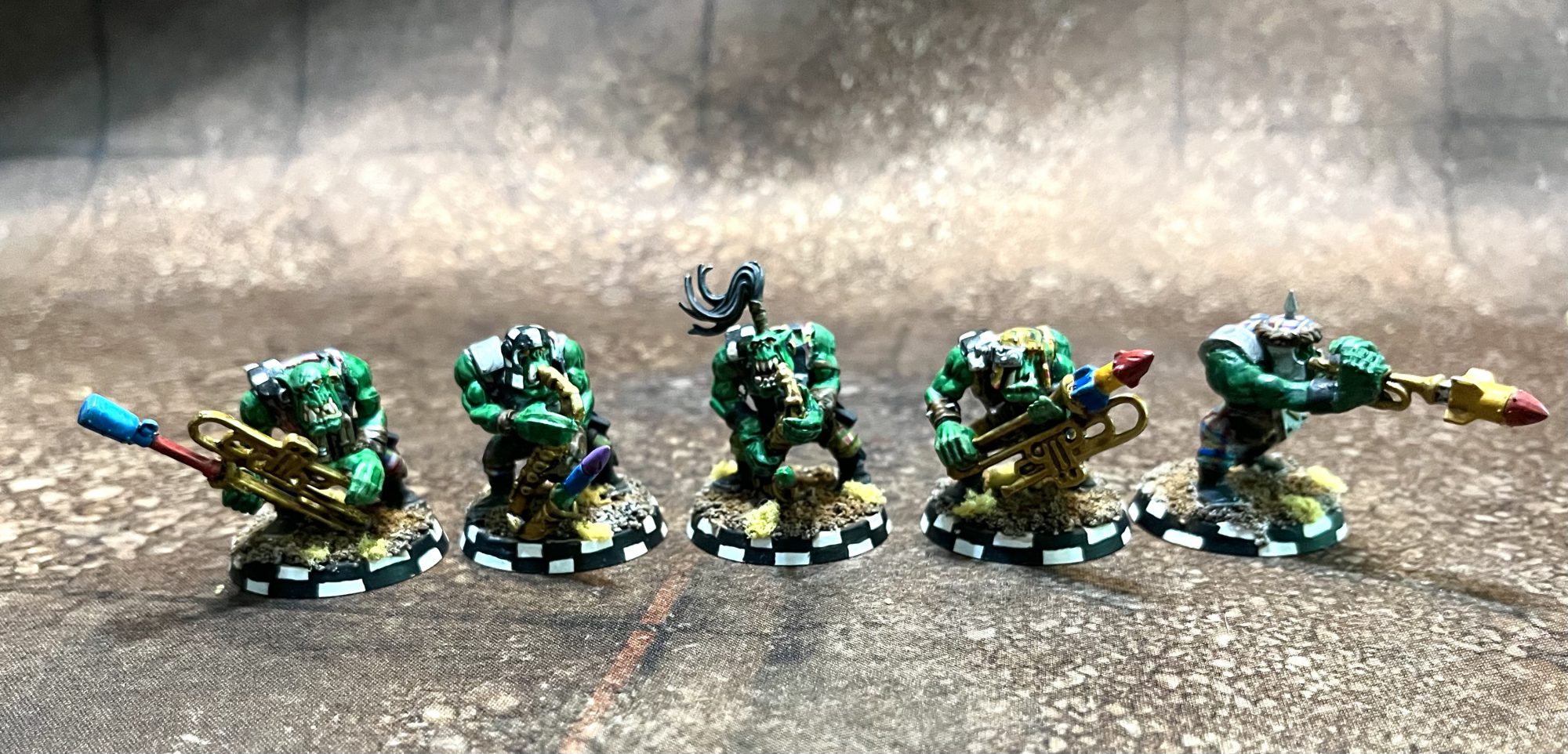Five orks with musical instruments laden with explosives