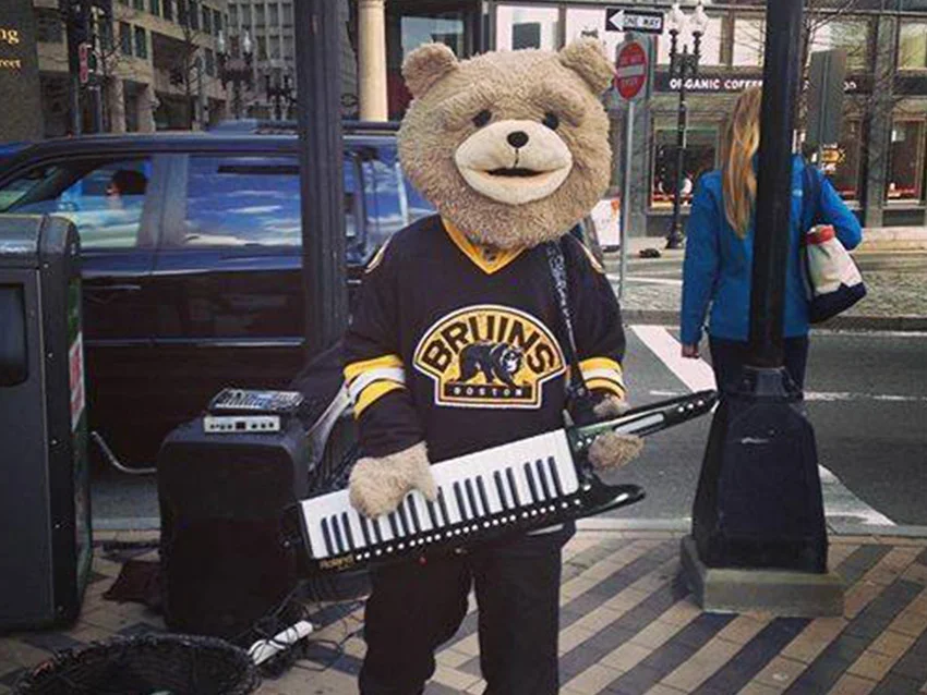 A person in a bear costume with a keytar