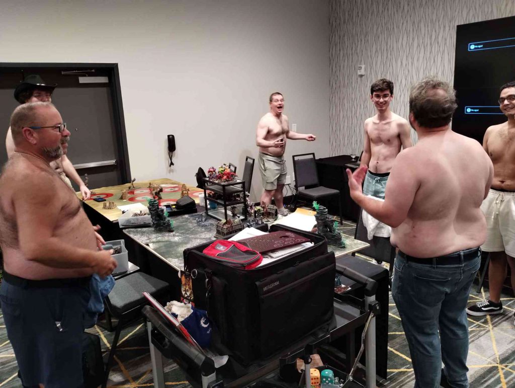 Several Men without shirts in a room