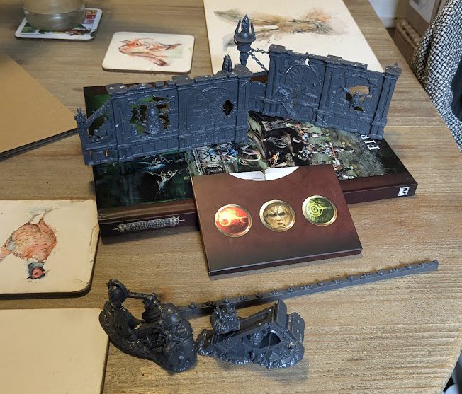 cards, unpainted terrain and rat measuring tool from Spearhead: Fire and Jade. Credit: Roxin