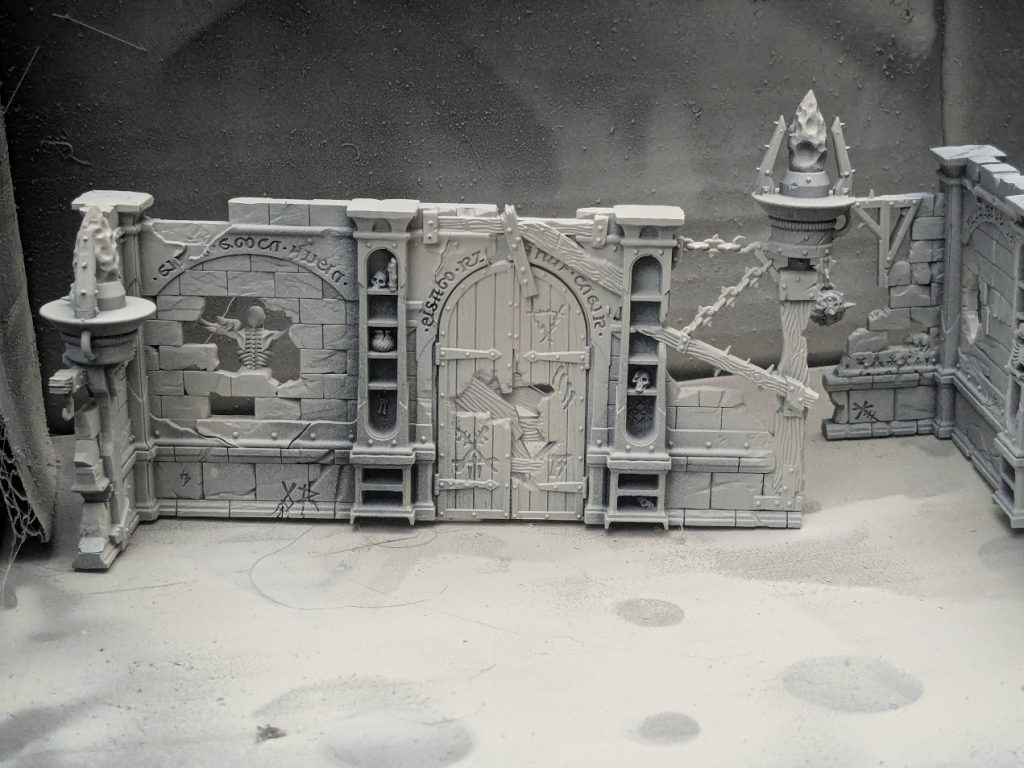 primed terrain from Spearhead: Fire and Jade, featuring Skaven graffiti and warpstone braziers. Credit: Roxin