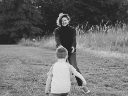 Black and white photograph of Amber Cook, reaching for her son James, from her GFM campaign page.