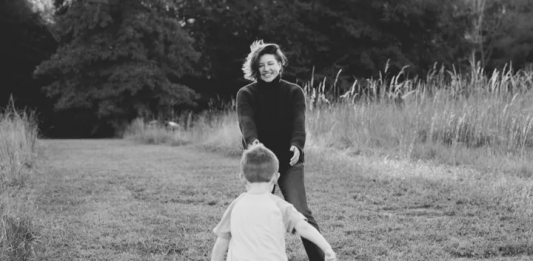 Black and white photograph of Amber Cook, reaching for her son James, from her GFM campaign page.