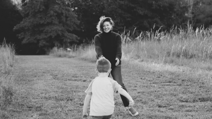 Black and white photograph of Amber Cook, reaching for her son James, from her GFM campaign page.