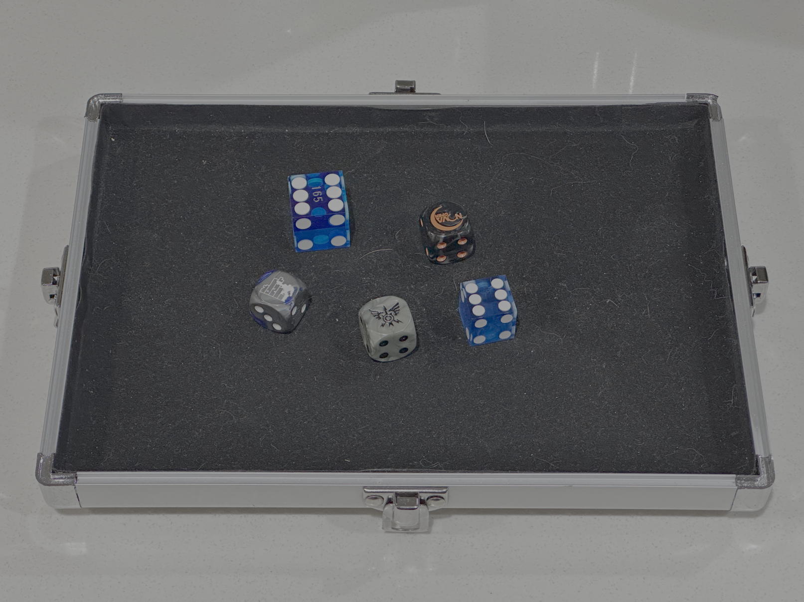 Five dice sitting in a dice tray