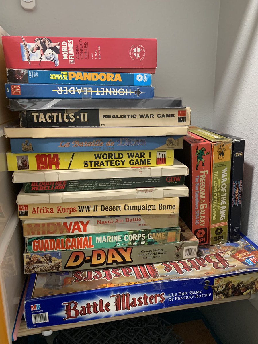 A pile of hex-and-counter games on a closet shelf.