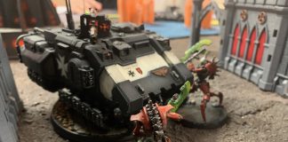 A Black Templar tank is attacked by Necrons