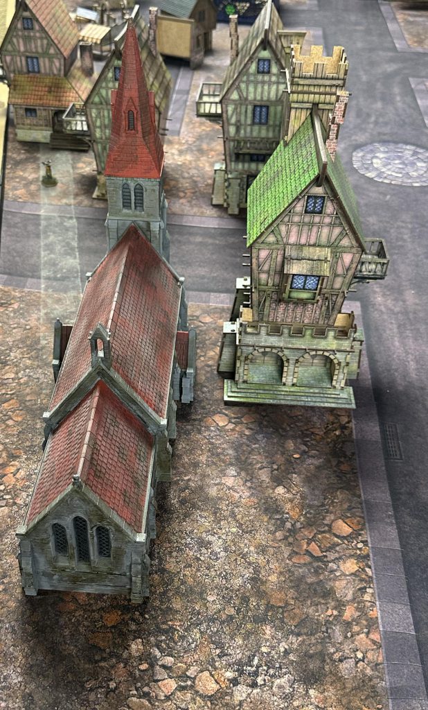 A cathedral and a large Tollingchester house next to each other